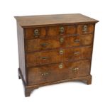 A George II crossbanded walnut chest, of three short and three graduated long drawers, on bracket