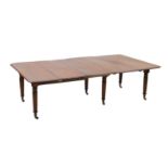 A Regency mahogany extending dining table, with rounded rectangular top and four leaves, on six