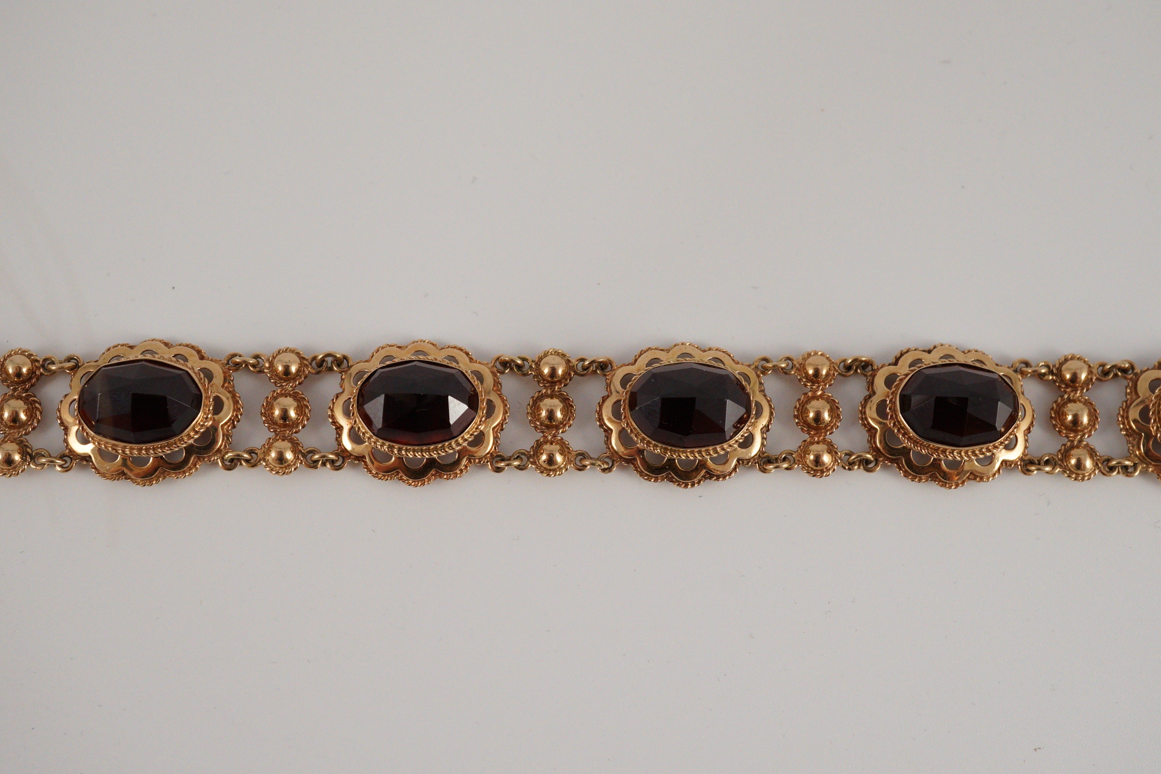 A 20th century Dutch 14k gold and six stone facet cut cabochon garnet set fancy link bracelet, 19cm, - Image 6 of 9