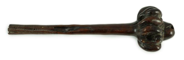 A Fijian hardwood throwing club, with zig-zag relief carved handle and further irregular spotted