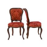 A set of twelve Victorian mahogany balloon back dining chairs, with floral carved show wood