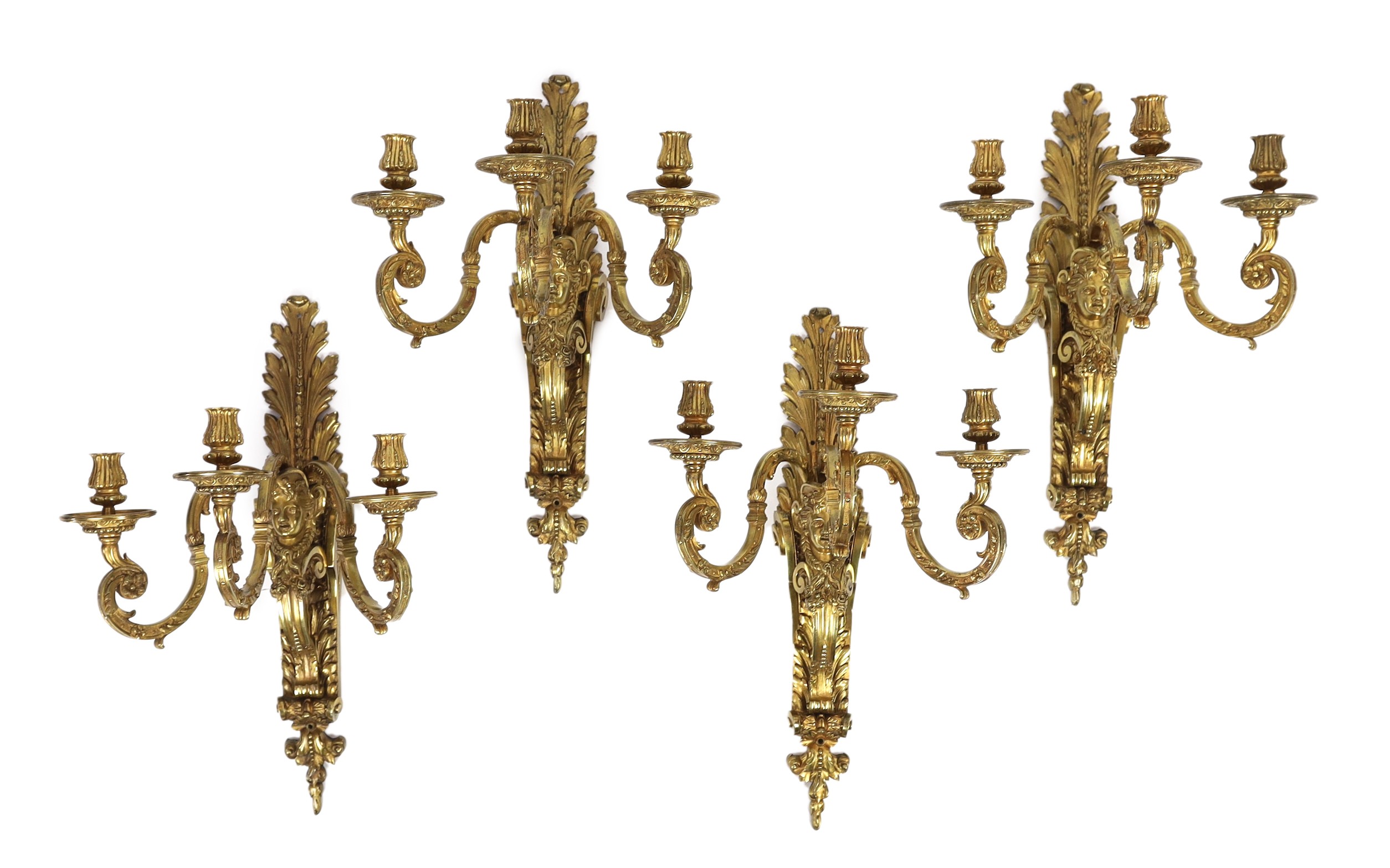 A set of four early 20th century Louis XVI style ormolu three branch wall lights, with acanthus,