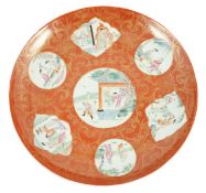 A Chinese coral ground dish, Qianlong seal mark but Republic period, painted in famille rose