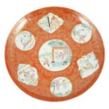 A Chinese coral ground dish, Qianlong seal mark but Republic period, painted in famille rose