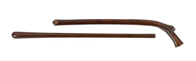 Two Tongan hardwood war clubs, one with curved tip to the head, the other of plain tapered form,
