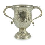 A George III silver baluster two handled pedestal cup, with later embossed decoration, by John