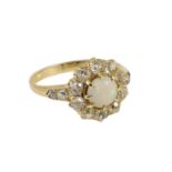 An early 20th century gold, white opal and diamond set circular cluster ring, with graduated diamond
