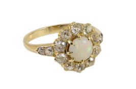 An early 20th century gold, white opal and diamond set circular cluster ring, with graduated diamond