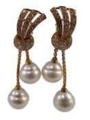 A modern pair of gold (tests as 18ct) and two stone South Sea pearl and diamond cluster set double