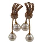 A modern pair of gold (tests as 18ct) and two stone South Sea pearl and diamond cluster set double