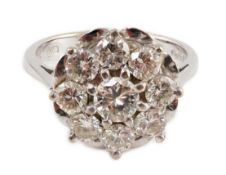A modern 18ct white gold and nine stone diamond illusion set circular cluster ring, size M/N,
