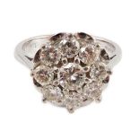 A modern 18ct white gold and nine stone diamond illusion set circular cluster ring, size M/N,