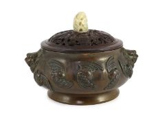 A large Chinese bronze ding censer, the wood cover with pale celadon jade finial, the censer cast in