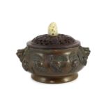 A large Chinese bronze ding censer, the wood cover with pale celadon jade finial, the censer cast in