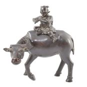 A Chinese bronze ‘boy riding a water buffalo’ censer, 17th/18th century, the figure of a boy playing