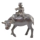 A Chinese bronze ‘boy riding a water buffalo’ censer, 17th/18th century, the figure of a boy playing