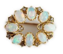 An Edwardian gold, eight stone oval opal set oval brooch, with diamond chip spacers, 20mm, gross