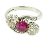 An 18ct white gold and platinum, two stone diamond and single stone synthetic? ruby set crossover