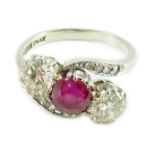 An 18ct white gold and platinum, two stone diamond and single stone synthetic? ruby set crossover