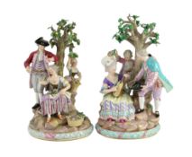A pair of Meissen groups of apple pickers and flower gatherers, 19th century, blue crossed swords