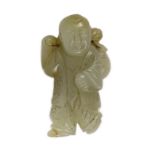 A Chinese pale celadon jade figure of a boy, 19th century, standing and holding a lotus sprig in his