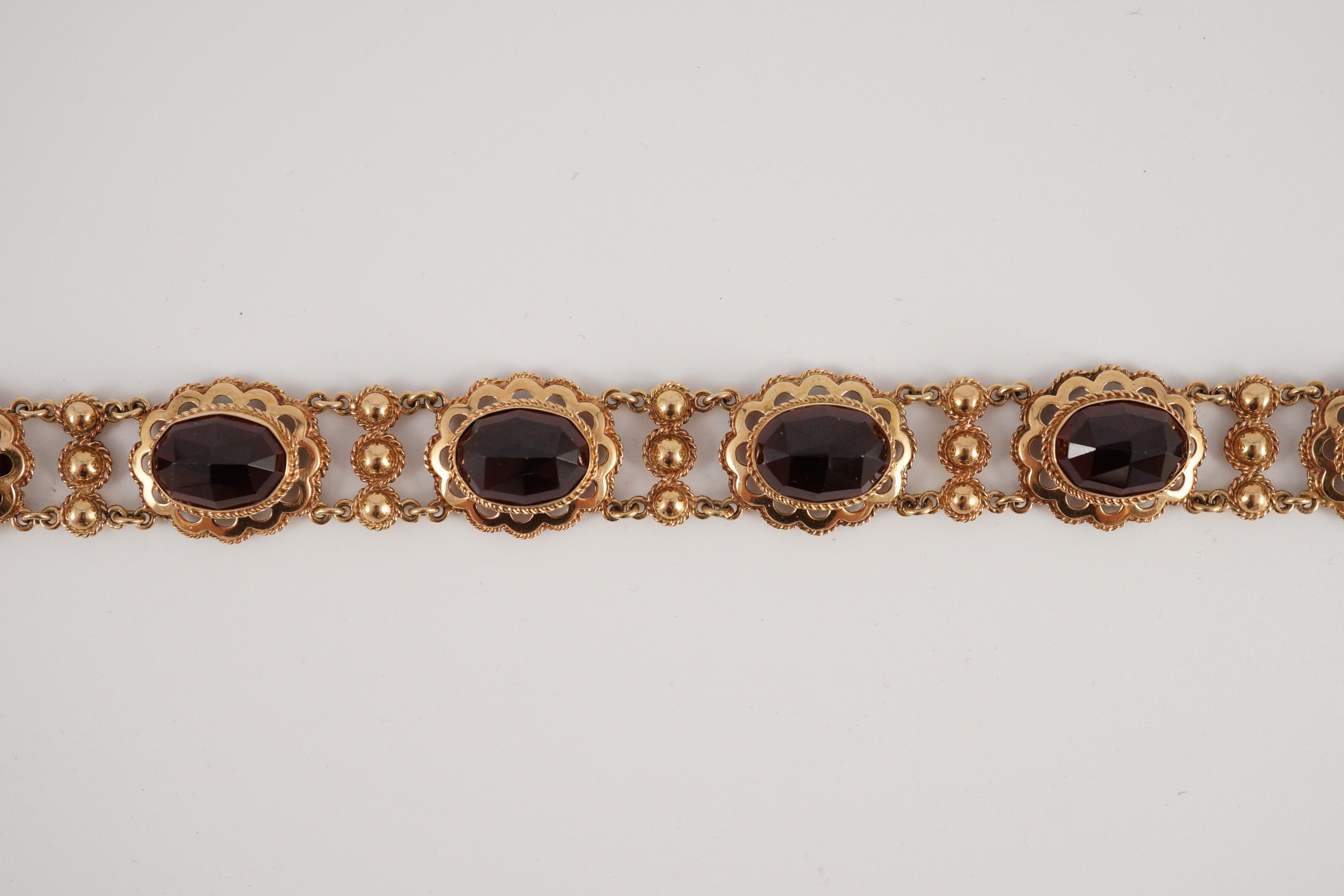 A 20th century Dutch 14k gold and six stone facet cut cabochon garnet set fancy link bracelet, 19cm, - Image 3 of 9