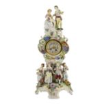 An impressive German porcelain floral encrusted figural mantel clock, late 19th century, modelled