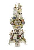 An impressive German porcelain floral encrusted figural mantel clock, late 19th century, modelled