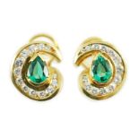 A modern pair of gold (tests as 18ct), emerald and diamond set scrolling cluster earrings, total