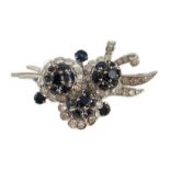 A white gold, sapphire and diamond cluster set floral spray brooch, 53mm, gross weight 18.8