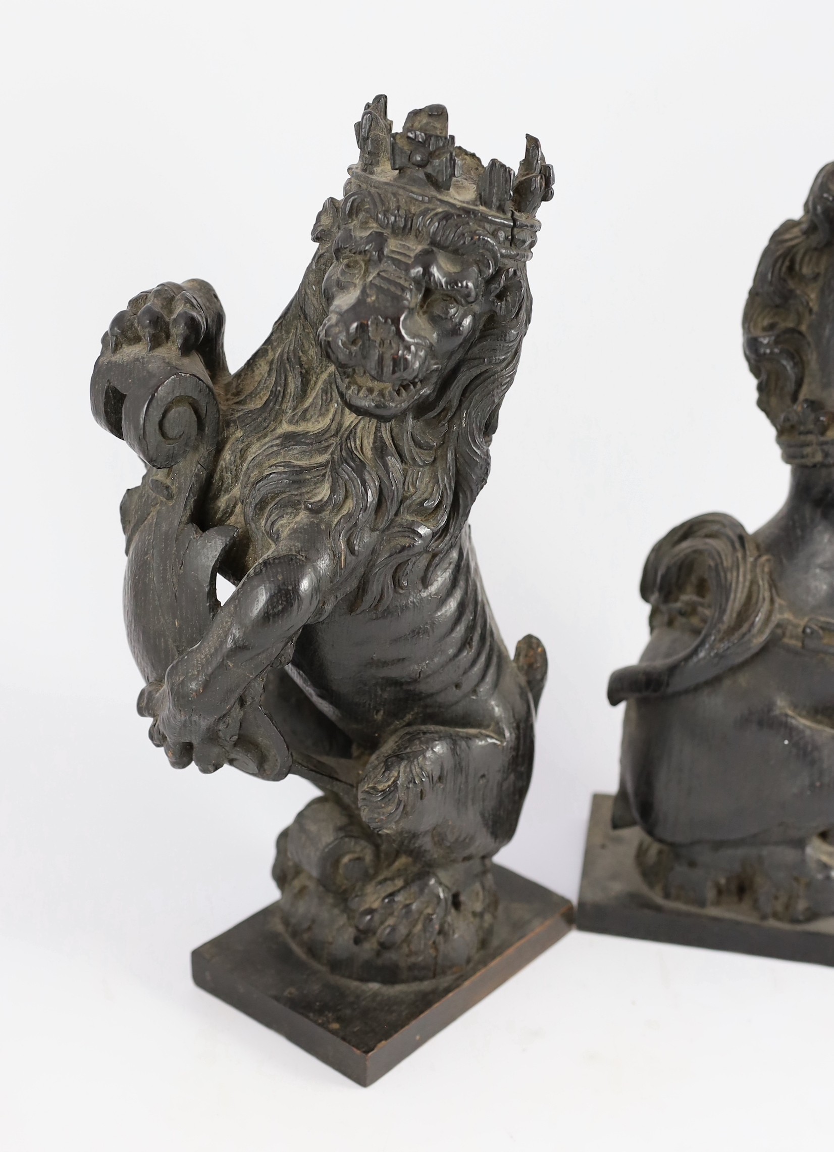 A pair of 18th century carved and ebonised oak heraldic beasts, lion and unicorn, each holding - Bild 2 aus 6