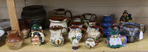 A collection of Doulton vessels and Torquay Mottoware,