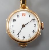 A lady's George V 15ct gold lady's manual wind wrist watch, London, 1918, on a 15ct flexible