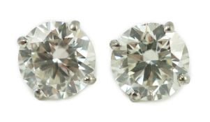 A pair of 750 white metal and solitaire diamond set ear studs, each stone weighing approximately 1.