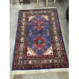 A Caucasian blue ground geometric rug, 240 x 160cm