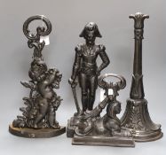 A cherubic cast iron door stop, another of Napoleon, a sphinx and another,(4)Napoleon 40 cms high,