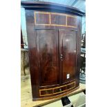 A George III banded mahogany hanging corner cabinet, width 82cm, height 126cm