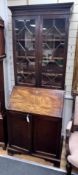 A George III mahogany bureau bookcase of narrow proportions with panelled cupboard base, width 77cm,