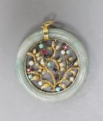 A 14k yellow metal and multi gem set circular jade pendant, diameter 51mm, gross weight 28.8 grams.
