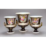 A garniture of three early 19th century floral painted Derby vases, tallest 20cm