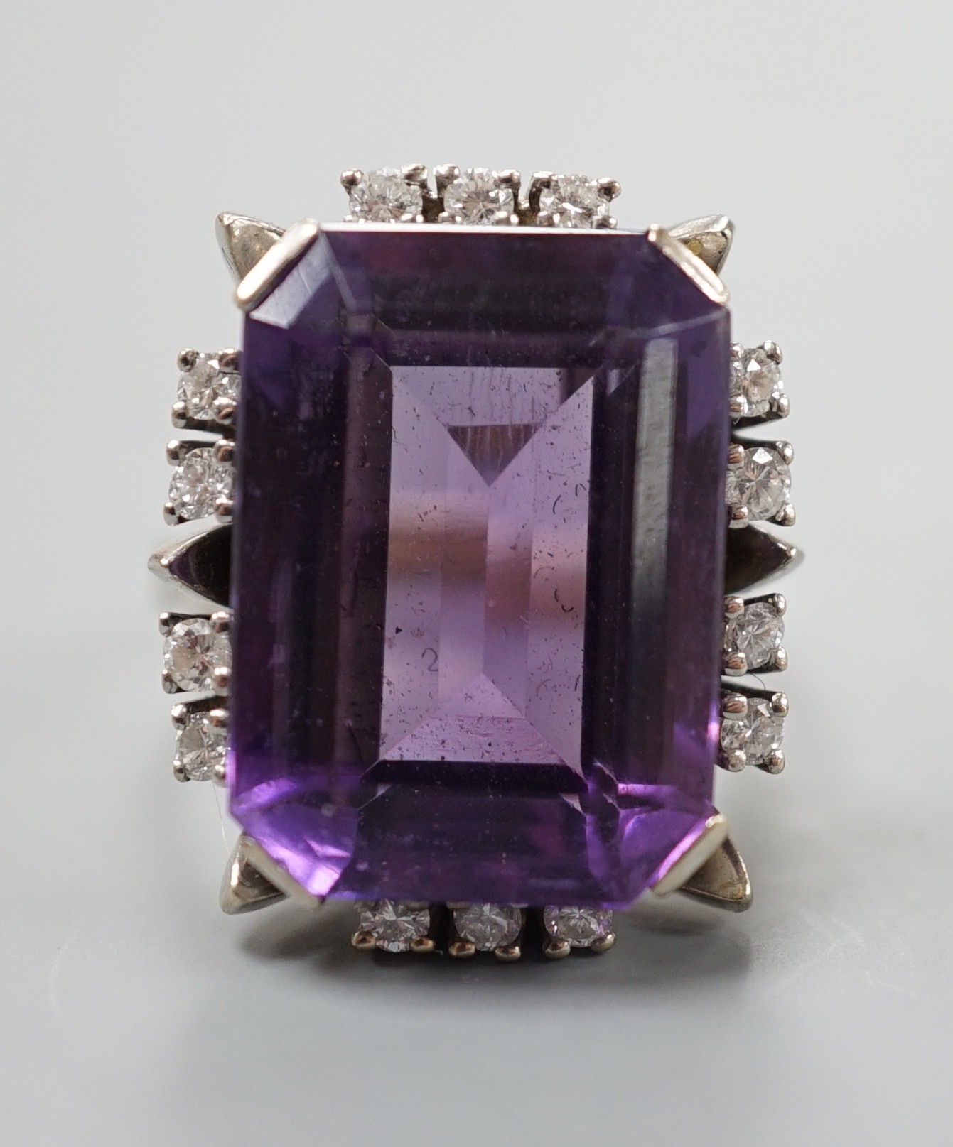 A 585 white metal emerald cut amethyst and diamond set cluster ring, size L, gross weight 11.5