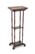 An early Victorian rosewood etagere, the rectangular top with pierced ormolu gallery, on turned