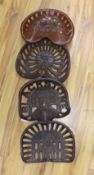 Four assorted cast iron and enamelled tractor seats,