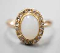 A yellow metal, white opal and rose cut diamond chip set oval ring, size O, gross weight 3 grams.