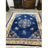 A Chinese blue ground carpet with floral field, 315 x 245cm