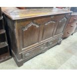 A mid 18th century oak mule chest with arched triple panelled front, width 144cm, depth 51cm, height
