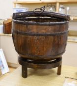 A Chinese wooden water bucket and carrying handle on stand,55cms including stand,