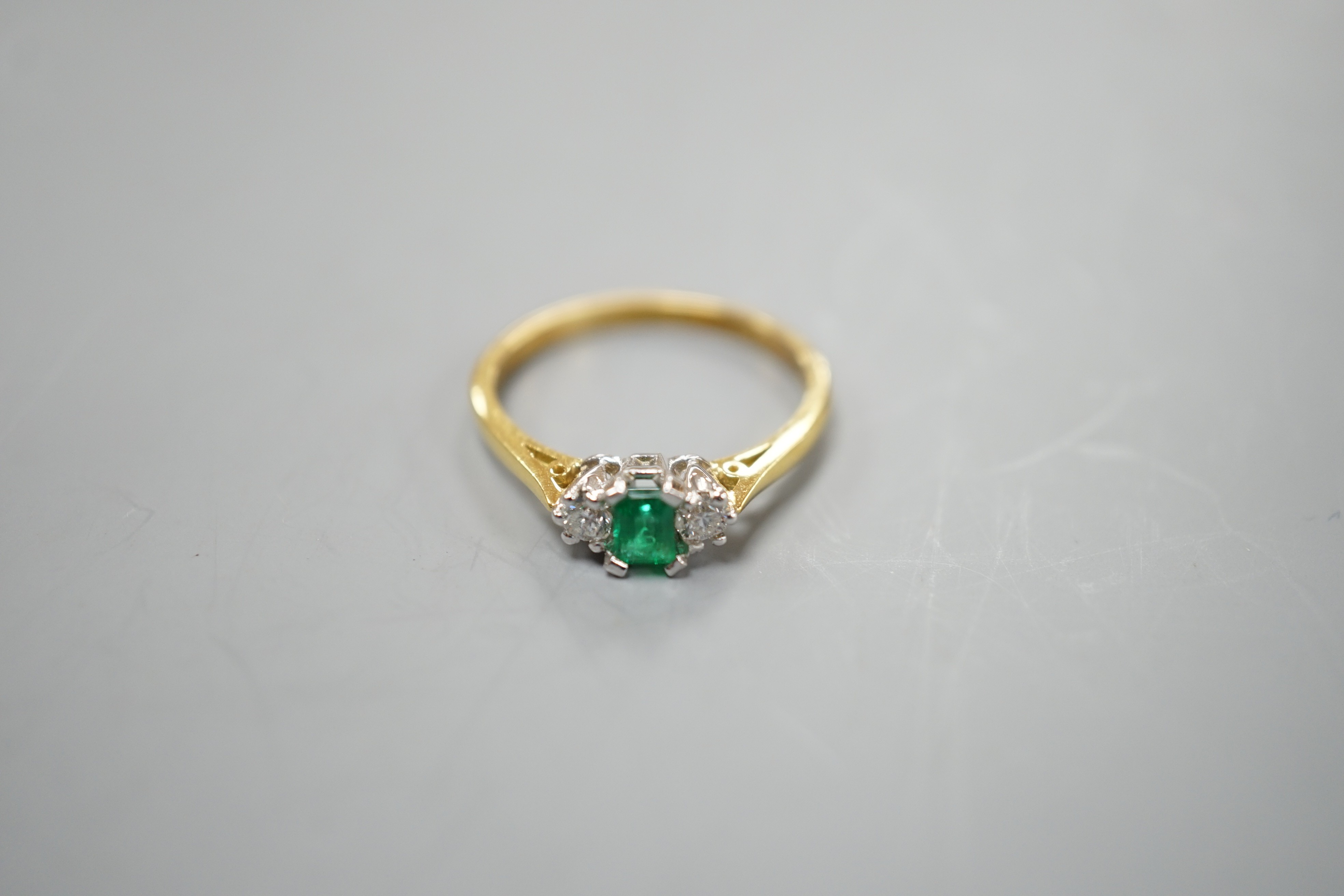 A modern 18ct gold, emerald and diamond set three stone ring, size N, gross weight 2.6 grams. - Image 2 of 3