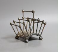 A Victorian Cristopher Dresser for Hukin & Heath silver plated seven bar toastrack, of fan shape, on