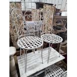 A set of four painted wrought iron garden chairs, height 96cm